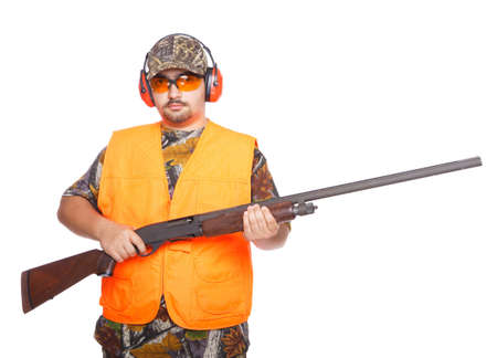 Hunter wearing a orange jacket while holding a shotgun, isolated on white