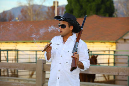 Cowboy smoking a cigar and holding his rifle