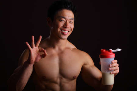 Perfect finger gesture for Protein Drink holding a jarの写真素材