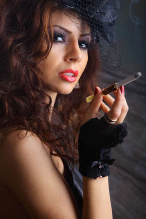 Glamour girl studio portrait , holding pipeの写真素材