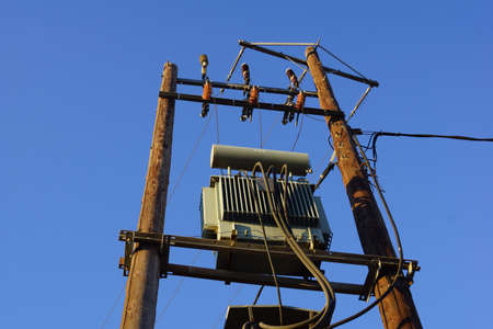 A small electricity substation against the blue sky 
