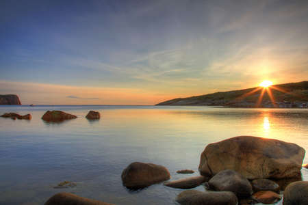 Sunrise along a rocky shoreline. の写真素材