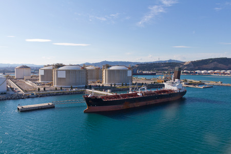 Oil tanker moored at a oil storage terminalの写真素材