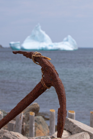 Anchor in foreground with iceberg in background.の写真素材