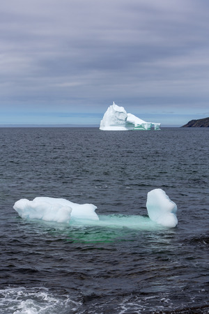 Large 10,000 year old iceberg drifting along the Newfoundland coastline in summer.の写真素材