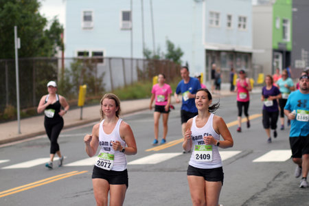 ST. JOHN'S, NEWFOUNDLAND AND LABRADOR, CANADA - JULY 22, 2018. Unidentified runners compete in the 91st Tely 10 road race, taken on July 22, 2018 in St. John's.のeditorial素材