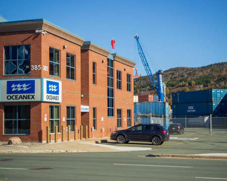 ST. JOHNâS, NEWFOUNDLAND AND LABRADOR, CANADA â OCTOBER 27, 2018: The Oceanex shipping terminal main office with cranes and containers, taken on October 27 in St. Johnâs.のeditorial素材