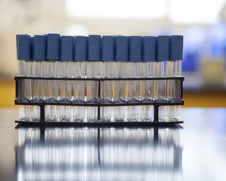 A rack containing empty test tubes in a microbiology lab.の写真素材