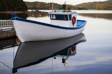 A fishing boat moored at the dock.の写真素材