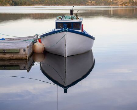 A fishing boat moored at the dock.の写真素材