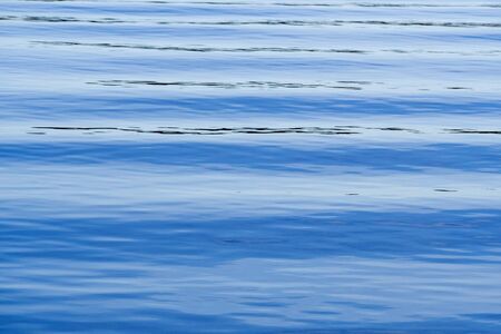 Ocean waves with blue tones on a calm day.