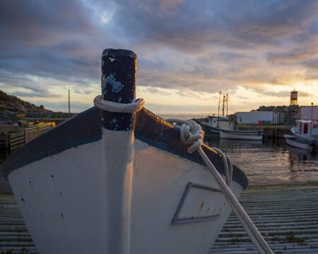 Mooring rope tied to a small fishing boat on a slipway.の写真素材