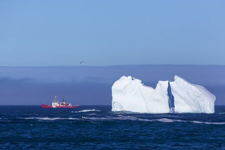 An iceberg along the Newfoundland coastline in summer, very popular with tourist.