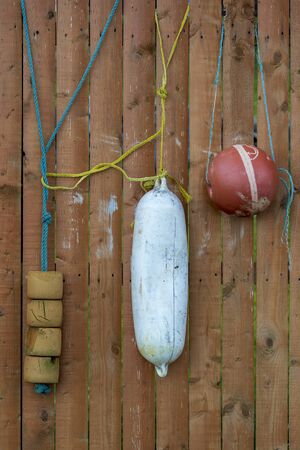 Marine floats used as decorations on a fence.