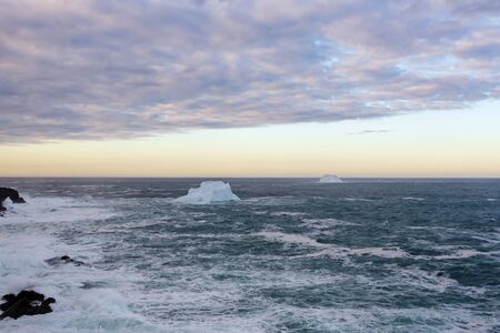 An iceberg along the Newfoundland coastline in summer, very popular with tourist.の写真素材