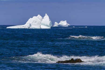 An iceberg along the Newfoundland coastline in summer, very popular with tourist.の写真素材