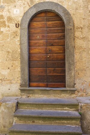 Brown door at the top of the steps.の写真素材