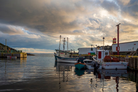 BAULINE, NEWFOUNDLAND AND LABRADOR, CANADA â JULY 22, 2019. Fishing boats moored at the dock during late evening, taken on July 22 in Bauline.のeditorial素材