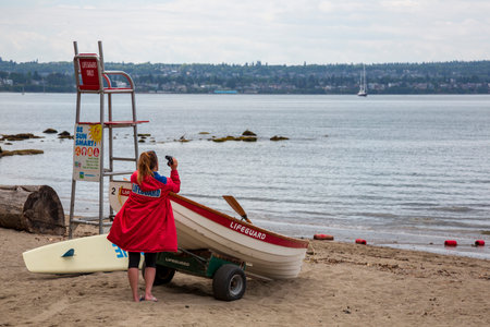 VANCOUVER, BRITISH COLUMBIA, CANADA, - JUNE 23, 2019. Early morning at a lifeguard station with the lifeguard watching the ocean, taken on June 23, 2019 in Vancouver.のeditorial素材