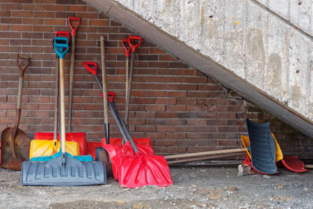 Snow shovels resting against a building.の写真素材