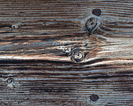 Coal tar treated wooden plank showing weathering.の写真素材