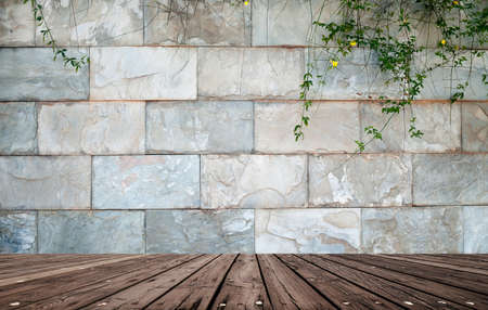 brick wall with green leaves