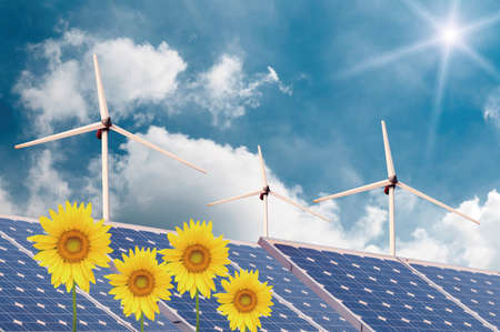 Wind turbines and solar panels on sunflowers fieldの写真素材