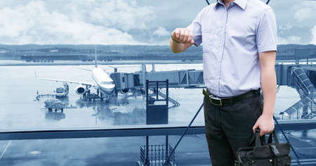 Young Businessman is waiting in the airport waiting hal and he checks the time on his watch.のeditorial素材