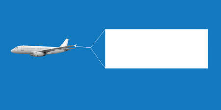 An airplane flying through the sky pulling a blank white banner to add your own message.の写真素材