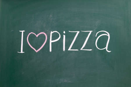 I love pizza handwritten with white chalk on a blackboard.の写真素材