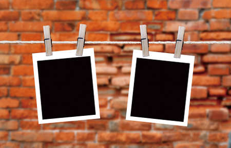 blank instant photos hanging on the clotheslineの写真素材