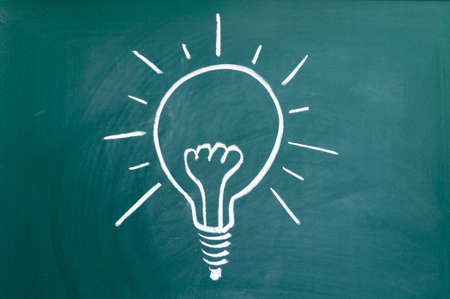 Light bulb on blackboard backgroundの写真素材
