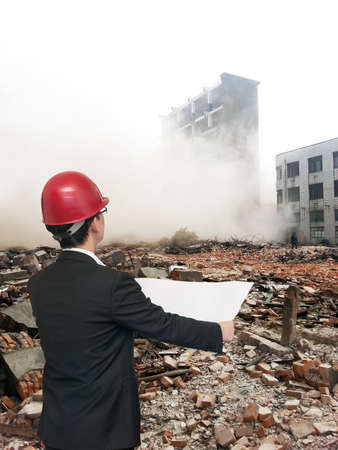 Rear view of architect looking comparing housing project with building