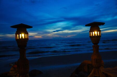 Two lampposts' silhouettes on dark blue skyの写真素材