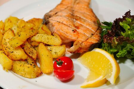 Grilled fish with potato and vegetablesの写真素材