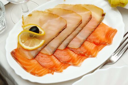 smoked fish on white plateの写真素材