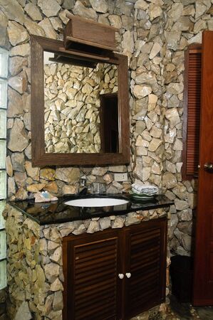 Thai style bathroom with stone wallsの写真素材