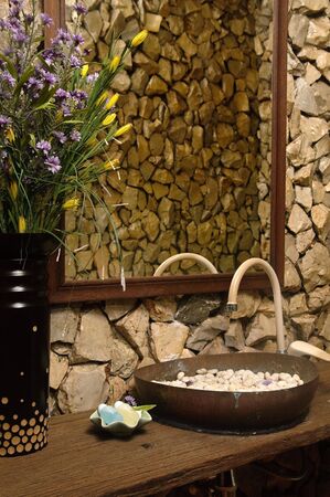 Thai style bathroom with stone wallsの写真素材