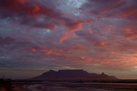 Red colored clouds above the iconic Table Mountain in Cape Town, South Africa.の写真素材