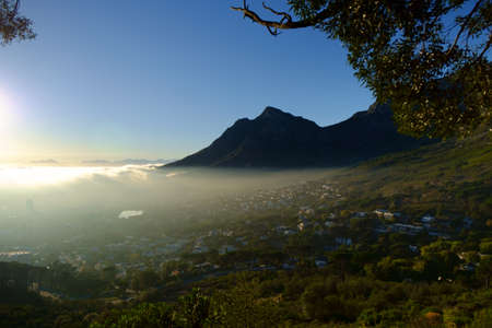 Early morning fog makes its way over the city of Cape Town.の写真素材
