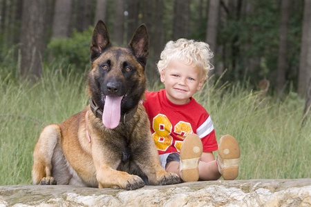 lovely blond boy with dogの写真素材