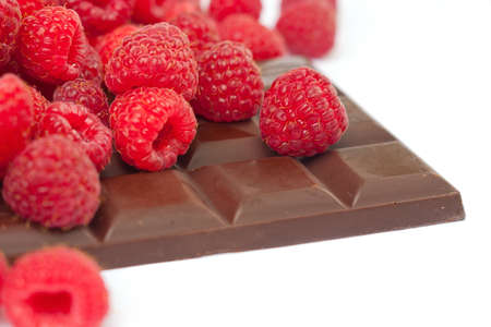 raspberries with chocolate on whiteの写真素材