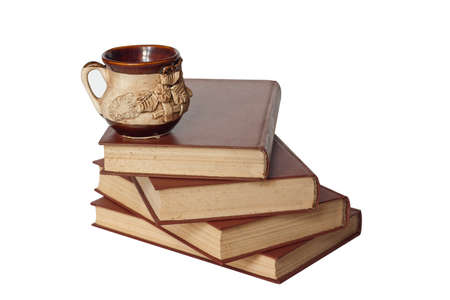 old books and a cup isolated on whiteの写真素材