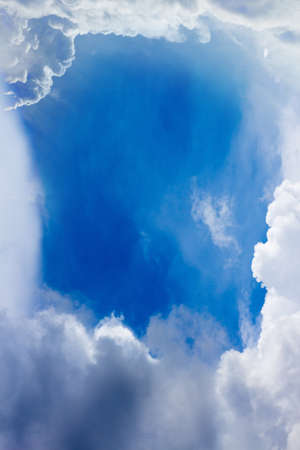 white clouds as frame in blue skyの写真素材