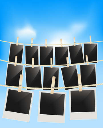 Photo frames hanging on clothesline with clothespins on blue sky background . Blank retro photographic framesのイラスト素材