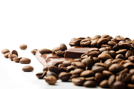 coffee beans and chocolate pieces on white backgroundの写真素材