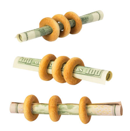 bagels with dollars on white. earnings, bankruptcy, savings or other business symbolの写真素材