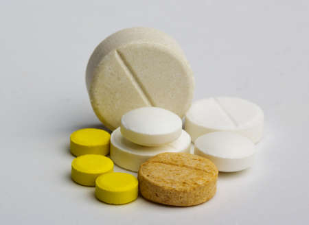 Various colored types of pills on a white background medicine photo.