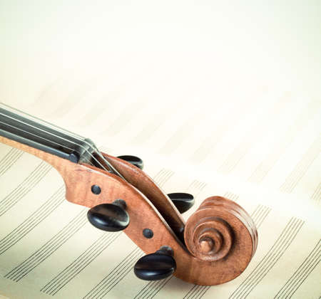 Old violin on musical note sheetsの写真素材
