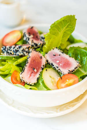 Grilled tuna salad in white bowl - healthy food